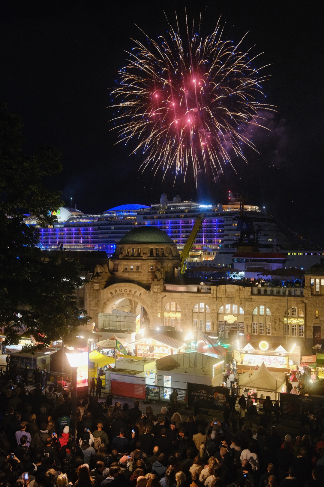 Feuerwerk über einem beleuchteten Schiff