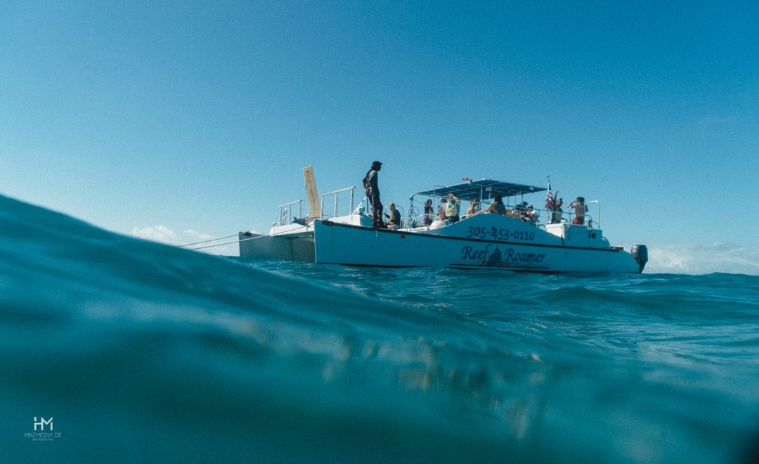 Boot auf türkisem Meer, von der Wasseroberfläche aus